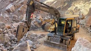 Training Test Caterpillar Wheel Loaders & Volvo Excavator Working On Mining Sites