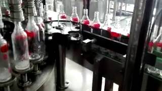 wine filling into the glass bottles