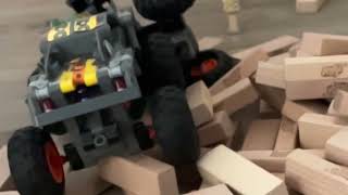 Monster Trucks Jamming Over a Pile of Jenga Bricks