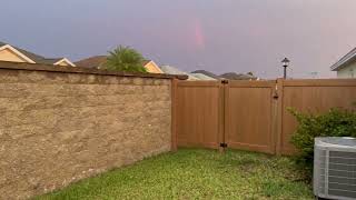 Late day rainbow and outside a designer veranda wall