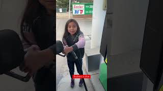 This little girl Pumping Gas.