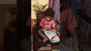 Alex, 22 months old kid is glancing over the Newspaper #morningactivity#Alex#readingnewspaper#shorts