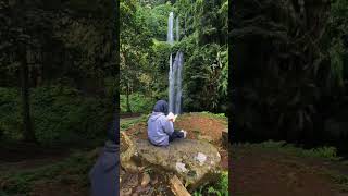 Reading book at the beautiful waterfall.