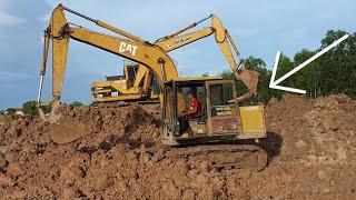 Heavy Equipment Excavators CAT Digging Ground To Make A Pond