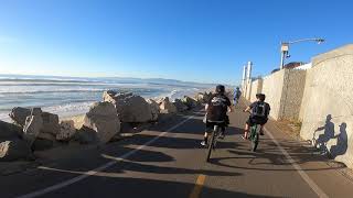 Kid & best pal trading secrets while biking on the beach