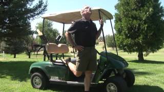 Standing Quad stretch on the golf cart