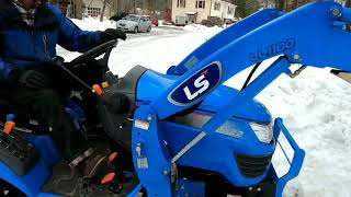 LS MT122 Tractor pulling A Honda Odyssey and moving snow.