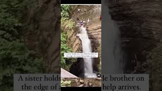 Sister holds onto her little brother on the edge of a waterfall as help arrives.❤