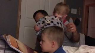 Daddy and boys reading