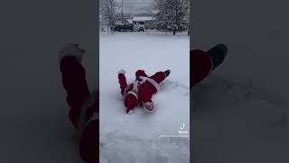 Santa and Mrs. Claus making snow Angels