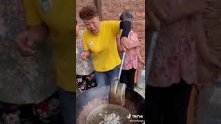 Chinese grandma cooking pork bones noodles