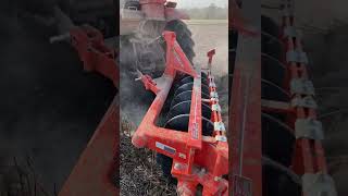 Tractors plow in hot weather