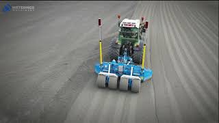 Weterings RW220T grader grading an artificial sports field preparation in Belgium