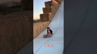 Sliding on the big giant Hay Bale Pile.