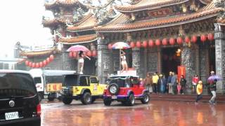 Girls pole dancing on Jeeps, at a temple in Taiwan.