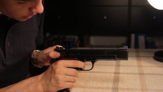 How to safely decock a rimfire pistol without damaging it through dry fire