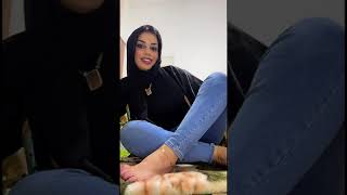 Hijab arab woman paints her feet toes