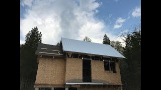 Insulating and Roofing a Timber Frame Cabin Roof Using Wrap and Strap and Galvalume