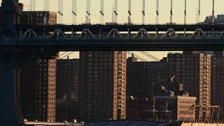 Subway train passing by composed with bridge and building architecture, in morning light.