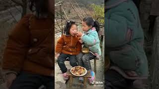 Little girl cooking for her sister