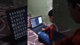 smart boy work in laptop he is answering the quit question @ smile plzz