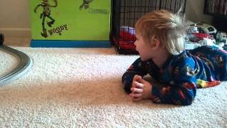 Christian watching his train go around the tree on Christmas morning