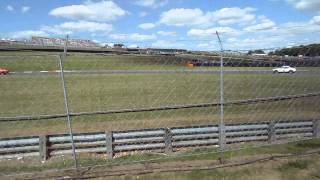 Bernie's Classic V8 Muscle Cars going through Graham Hill Bend after restart